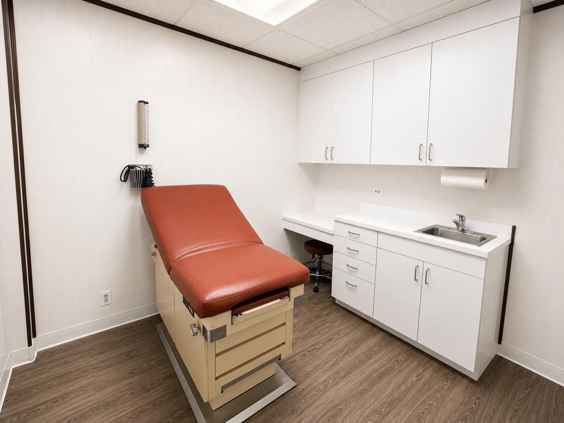 Exam room at Hourizadeh Medical Care with exam table and sink